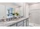 Well-lit bathroom featuring a double vanity with granite countertop and a shower at 3603 Salvia Ct, Tavares, FL 32778