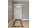 Bright front door with a half-round window bringing natural light into the home at 4154 Pinebark Ave # 3, Orlando, FL 32811