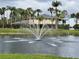 Picturesque pond featuring a decorative fountain surrounded by lush palm trees at 4154 Pinebark Ave # 3, Orlando, FL 32811