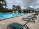 Community pool area with lounge chairs at 4154 Pinebark Ave # 3, Orlando, FL 32811