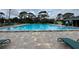 A refreshing community swimming pool with brick pavers and lounge chairs at 4154 Pinebark Ave # 3, Orlando, FL 32811