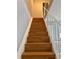 Staircase with wooden treads, white risers and white railing leading to the second floor at 4154 Pinebark Ave # 3, Orlando, FL 32811