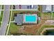 Overhead shot of community pool with a splash pad, lounge seating, parking lot, and landscaped grounds at 5593 Vigo Loop, St Cloud, FL 34771