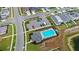 Aerial view of a community pool with lounge chairs, parking lot, and landscaping in a neighborhood at 5593 Vigo Loop, St Cloud, FL 34771