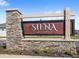 An attractive stone and wood sign welcomes residents to the Siena Reserve community at 5593 Vigo Loop, St Cloud, FL 34771