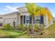 A view of the home's facade, with neat landscaping and blue shutters providing a pop of color at 5593 Vigo Loop, St Cloud, FL 34771