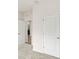 Hallway with neutral walls and flooring and an entrance to the laundry room at 5593 Vigo Loop, St Cloud, FL 34771