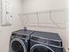 Laundry room featuring a side-by-side washer and dryer under a metal shelf at 5593 Vigo Loop, St Cloud, FL 34771