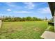 Expansive backyard featuring lush greenery and pond views, creating a serene outdoor space at 5663 Keaton Springs Dr, Lakeland, FL 33811