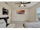 Bright bedroom with a ceiling fan, plush carpet, and a mounted TV at 5663 Keaton Springs Dr, Lakeland, FL 33811