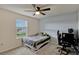 Comfortable bedroom featuring a plush carpet, ceiling fan, and a bright window at 5663 Keaton Springs Dr, Lakeland, FL 33811