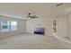 Spacious bonus room with a ceiling fan, tv and natural light from the nearby windows at 5663 Keaton Springs Dr, Lakeland, FL 33811