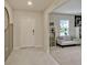 Inviting entryway with tile flooring, a white front door and a view into the adjacent living space at 5663 Keaton Springs Dr, Lakeland, FL 33811