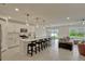 Bright, open-concept kitchen with white cabinets, a large island with seating, and stainless steel appliances at 5663 Keaton Springs Dr, Lakeland, FL 33811