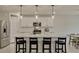 Modern kitchen features white cabinets, a large island with seating, stainless steel appliances, and pendant lighting at 5663 Keaton Springs Dr, Lakeland, FL 33811