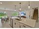 Bright, open kitchen with a center island, stainless steel appliances, and easy access to dining and living areas at 5663 Keaton Springs Dr, Lakeland, FL 33811