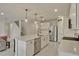 Open kitchen with white cabinets, a large island, stainless steel appliances, and tile flooring at 5663 Keaton Springs Dr, Lakeland, FL 33811