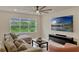 Bright living room featuring a large window offering natural light and a comfortable, oversized corduroy sofa at 5663 Keaton Springs Dr, Lakeland, FL 33811