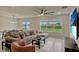 Bright and inviting living room features a large sectional sofa, modern decor, and an adjacent dining area at 5663 Keaton Springs Dr, Lakeland, FL 33811