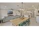 Open concept living space with kitchen island, dining area, living room, and stairs to the second floor at 5663 Keaton Springs Dr, Lakeland, FL 33811