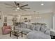 Bright living area with open layout, connecting kitchen, dining, and seating areas with a modern ceiling fan at 5663 Keaton Springs Dr, Lakeland, FL 33811