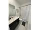 Bathroom featuring dark vanity with light countertop, modern shower and neutral-colored tiling at 695 Whistling Straits Blvd, Davenport, FL 33896