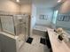 Bright bathroom showcasing dual sinks, a soaking tub, and a separate glass-enclosed shower at 695 Whistling Straits Blvd, Davenport, FL 33896