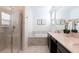 Bright bathroom with a glass-enclosed shower, bathtub, and a double vanity with marble countertops at 695 Whistling Straits Blvd, Davenport, FL 33896