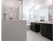 Bathroom featuring shower, tub, double vanity with dark cabinets and marble countertops at 695 Whistling Straits Blvd, Davenport, FL 33896