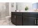 Contemporary bathroom with dark cabinets, modern fixtures, and glass-enclosed shower at 695 Whistling Straits Blvd, Davenport, FL 33896