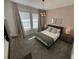 A stylish bedroom featuring recessed lighting, a modern chandelier, and neutral decor at 695 Whistling Straits Blvd, Davenport, FL 33896