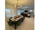 Elegant dining room featuring a stylish light fixture and a set table, perfect for entertaining guests at 695 Whistling Straits Blvd, Davenport, FL 33896