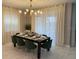 Inviting dining room featuring modern lighting and beautifully staged table at 695 Whistling Straits Blvd, Davenport, FL 33896