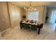 Elegant dining room with a chandelier and a beautifully set table for a memorable dining experience at 695 Whistling Straits Blvd, Davenport, FL 33896