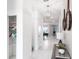 Bright hallway with decorative mirrors, pendant lighting, and an open view to the dining area at 695 Whistling Straits Blvd, Davenport, FL 33896