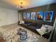 Cozy living room with a dark sofa, movie posters, and stylish decor at 695 Whistling Straits Blvd, Davenport, FL 33896