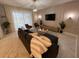 Bright living room featuring a modern black sofa, marble floors, and decorative lighting fixtures at 695 Whistling Straits Blvd, Davenport, FL 33896