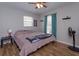 Comfortable bedroom with laminate floors, natural light, and a ceiling fan at 711 Montana Ave, St Cloud, FL 34769