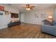 Spacious living room featuring wood floors, a ceiling fan, and a comfortable sofa at 711 Montana Ave, St Cloud, FL 34769