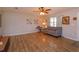 Bright living room featuring wood floors, a ceiling fan, and a comfortable sofa at 711 Montana Ave, St Cloud, FL 34769