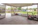 Enclosed patio overlooking the backyard with lawnmowers, concrete flooring, and screen enclosure at 711 Montana Ave, St Cloud, FL 34769