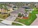 Aerial view of a home with a 3-car garage, landscaped yard, and brick driveway at 719 Postrio Way, Ocoee, FL 34761