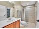 Bathroom with a large vanity, tiled shower and floors, and updated fixtures at 719 Postrio Way, Ocoee, FL 34761