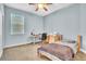 Bedroom with a desk and chair, twin bed, and natural lighting at 719 Postrio Way, Ocoee, FL 34761