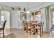 Dining area features a wooden table, six chairs, and sliding glass doors to the backyard at 719 Postrio Way, Ocoee, FL 34761