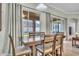 Dining area with a wooden table, six chairs, and sliding doors to the outside patio at 719 Postrio Way, Ocoee, FL 34761