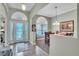 Elegant foyer leading to dining room with arched doorways, decorative lighting, and stylish decor at 719 Postrio Way, Ocoee, FL 34761