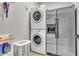 Laundry area featuring stacked washer and dryer and stainless steel refrigerator at 719 Postrio Way, Ocoee, FL 34761