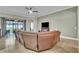 Spacious living room features tile floors, a ceiling fan, and glass sliding doors to the backyard at 719 Postrio Way, Ocoee, FL 34761