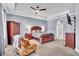 Comfortable main bedroom featuring a ceiling fan, a chair, and wood furniture at 719 Postrio Way, Ocoee, FL 34761